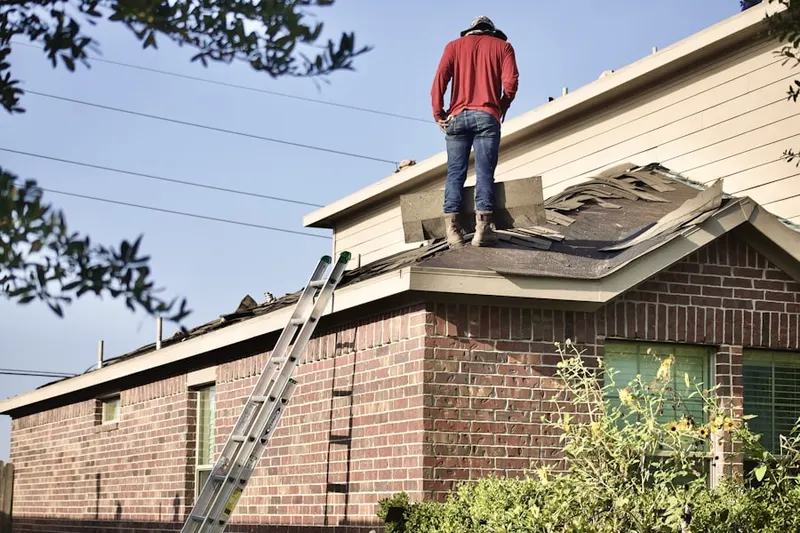 Professional roofer working on a residential roof in Rocky Nook Point